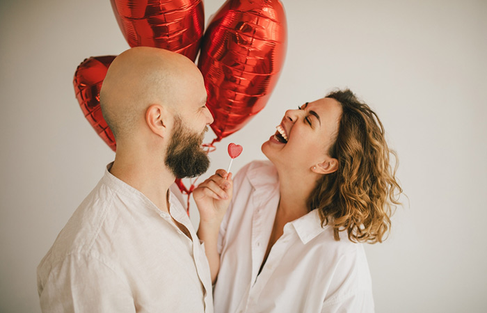 Man sharing a funny Valentine’s Day joke with girlfriend