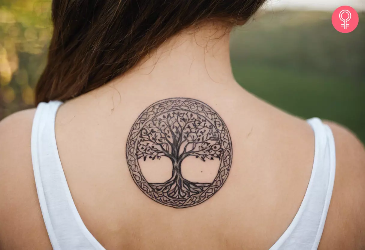 A woman with a Nordic tree of life tattoo design on her upper back