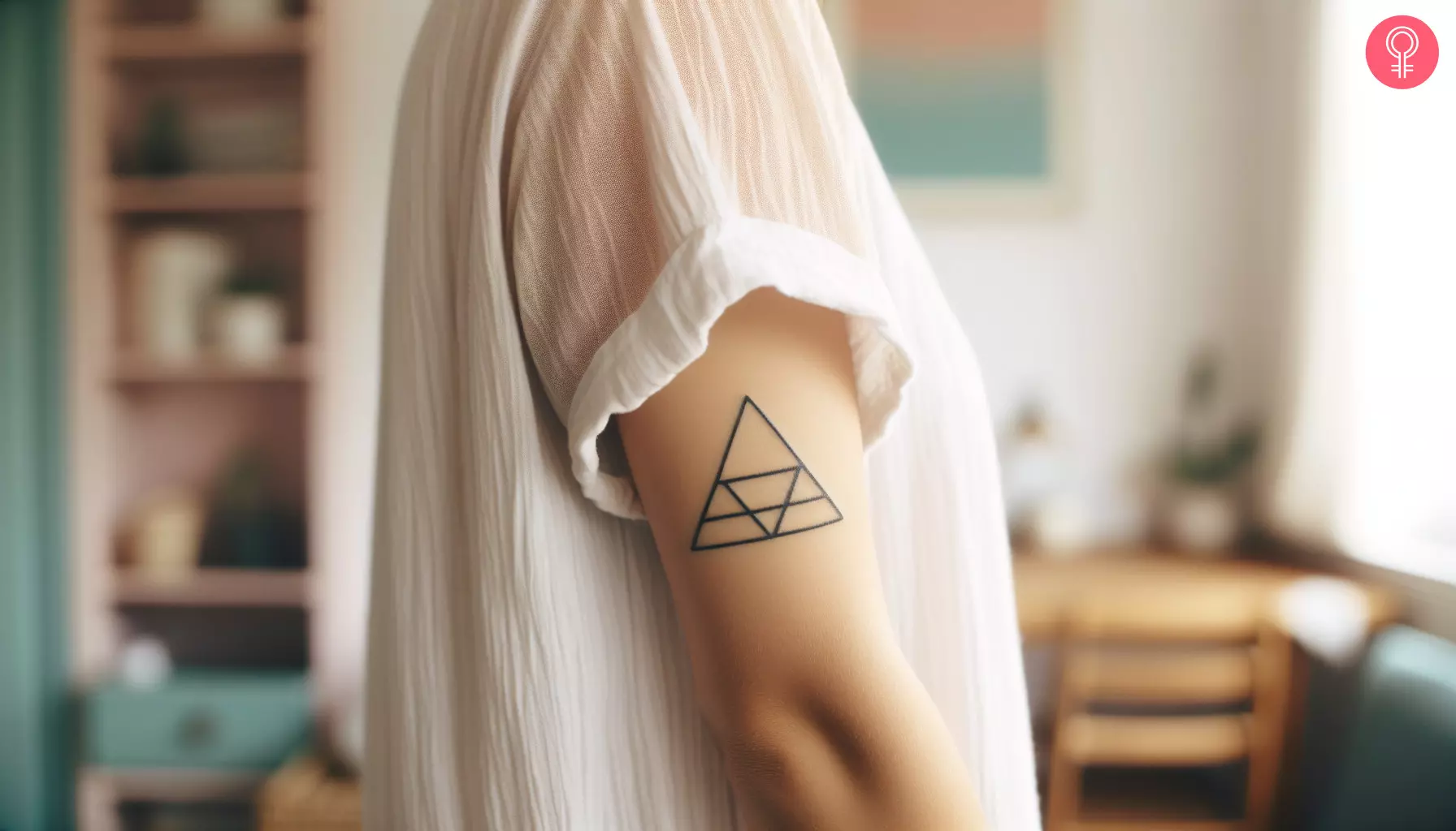 A woman with a Nordic triangle tattoo on her upper arm