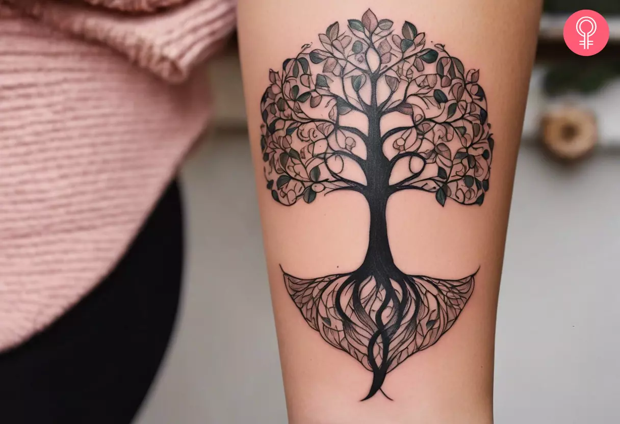 A woman with a feminine tree of life tattoo design on her arm