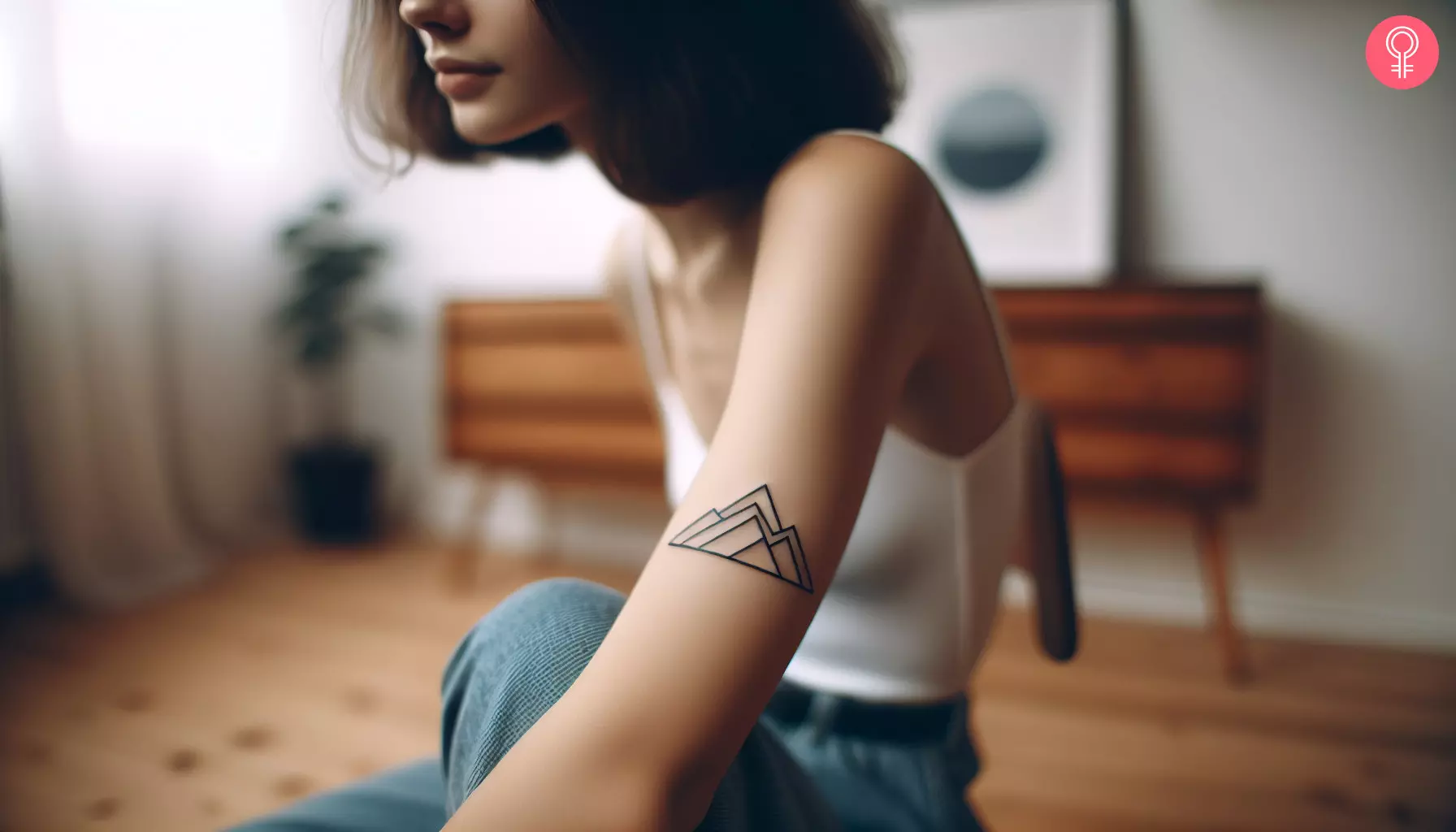 A woman with a geometric triangle mountain tattoo on her arm
