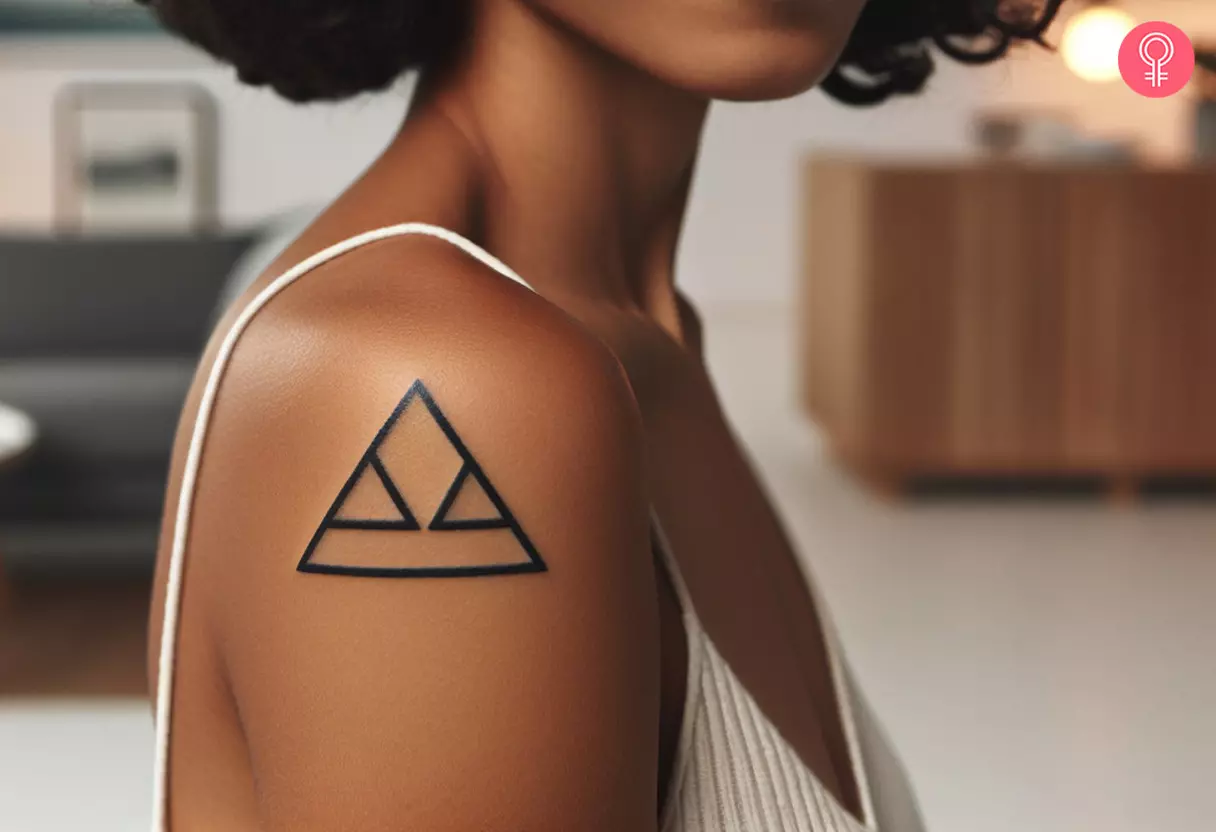 A woman with a small triangle tattoo on her upper arm