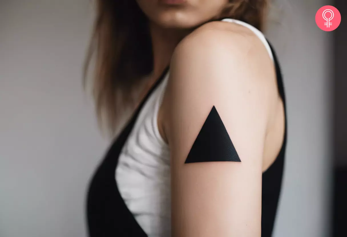 A woman with a solid triangle tattoo on her upper arm