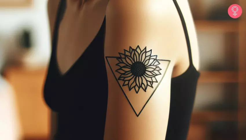 A woman with a sunflower triangle tattoo on her upper arm