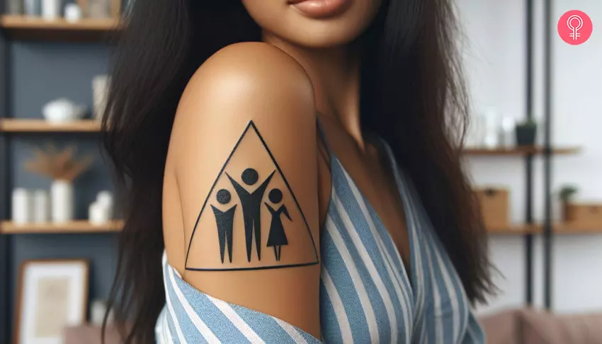 A woman with a triangle family tattoo on her upper arm