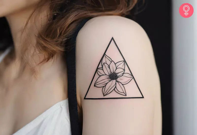 A woman with a triangle flower tattoo on her upper arm