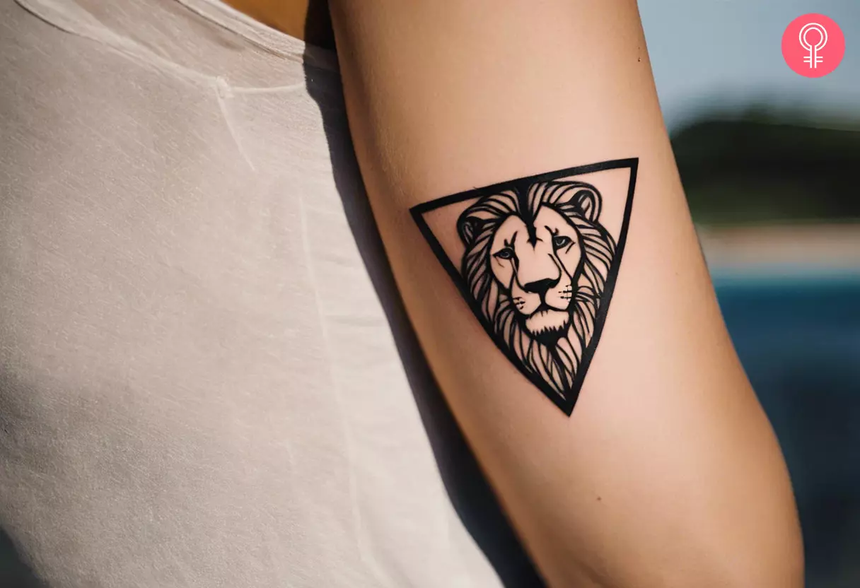 A woman with a triangle lion tattoo on her upper arm