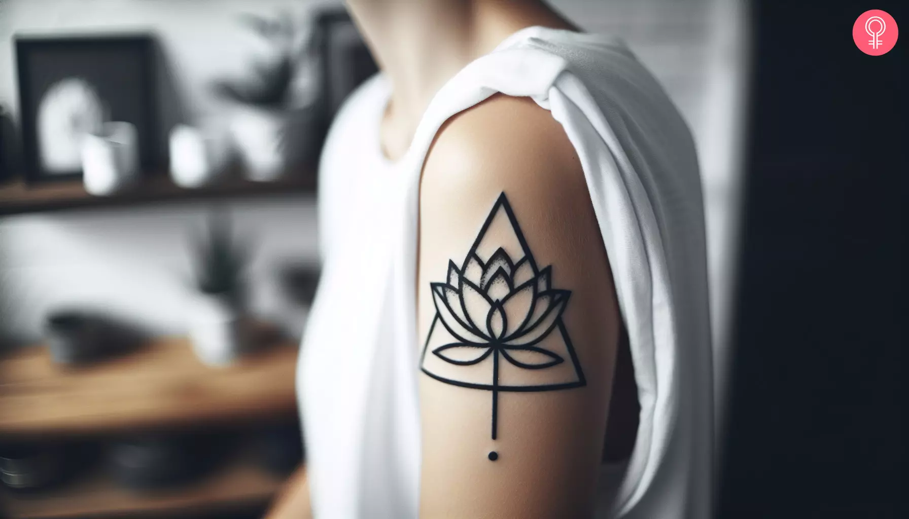 A woman with a triangle lotus tattoo on her upper arm