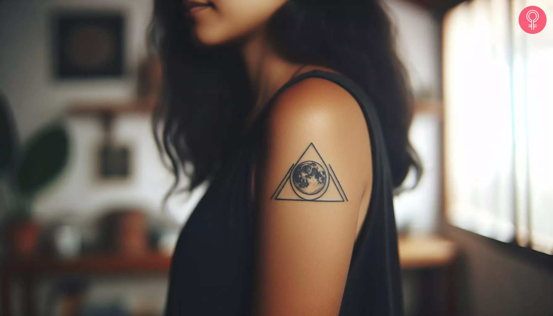 A woman with a triangle moon tattoo on her upper arm