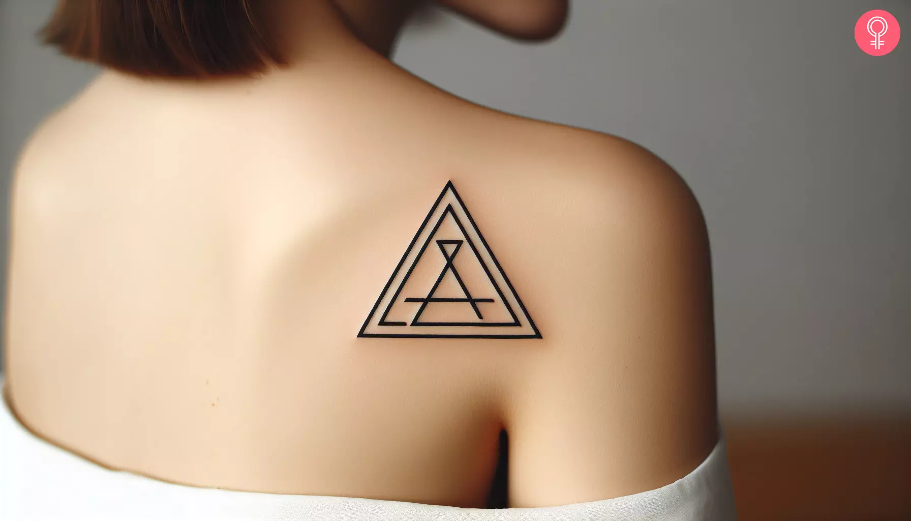 A woman with a triangle pattern tattoo on her upper back