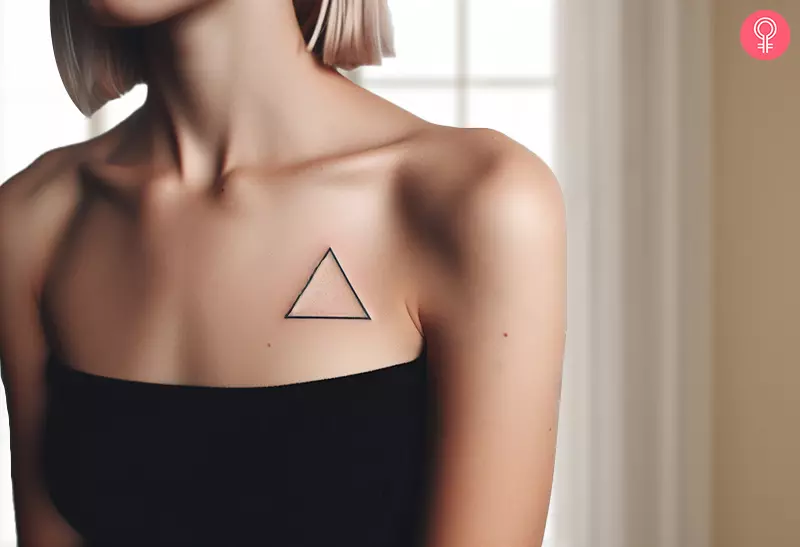 A woman with a triangle tattoo on her upper chest