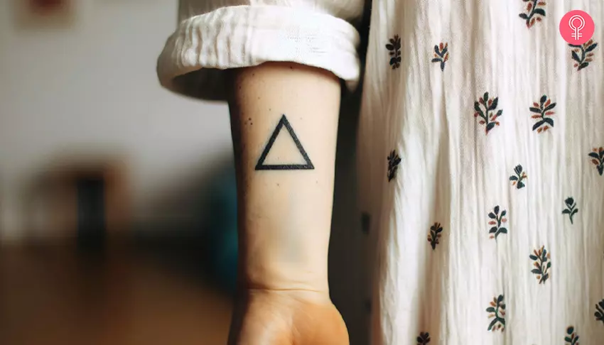 A woman with a triangle tattoo on her wrist