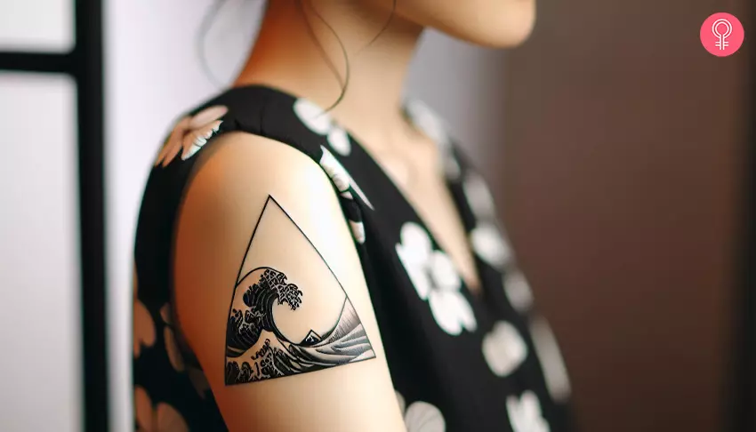 A woman with a triangle wave tattoo on her upper arm