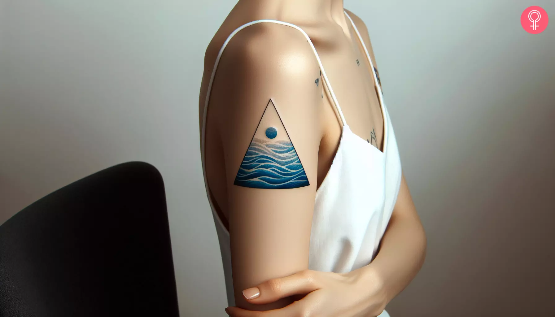 A woman with a water triangle tattoo on her upper arm