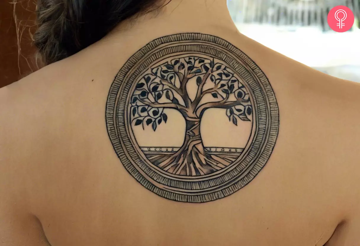 A woman with an Egyptian tree of life tattoo design on her back