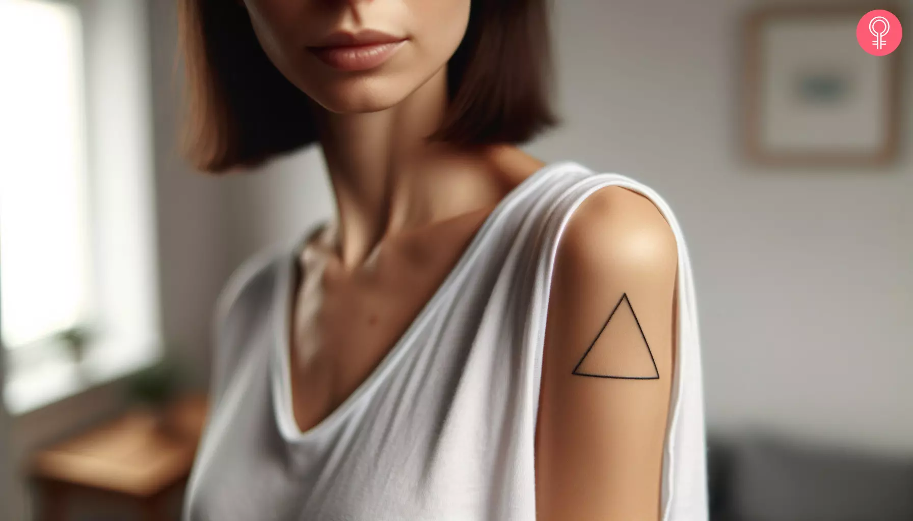 A woman with an equilateral triangle tattoo on her upper arm