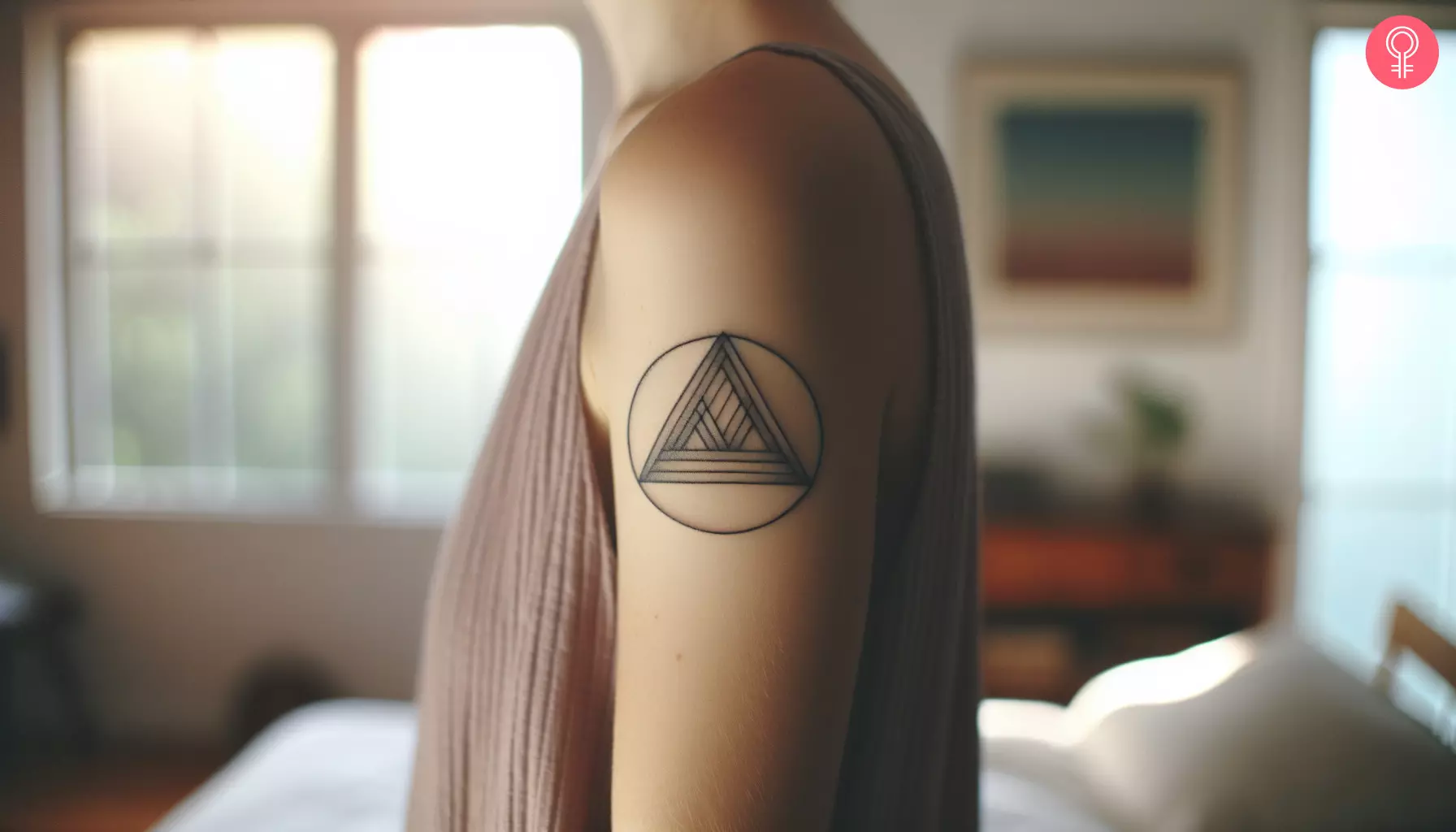 A woman with an inscribed triangle tattoo on her upper arm