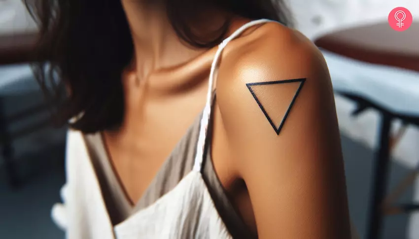 A woman with an inverted triangle tattoo on her upper arm