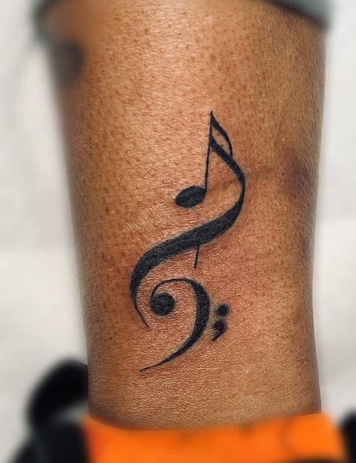 Semicolon tattoo with musical note