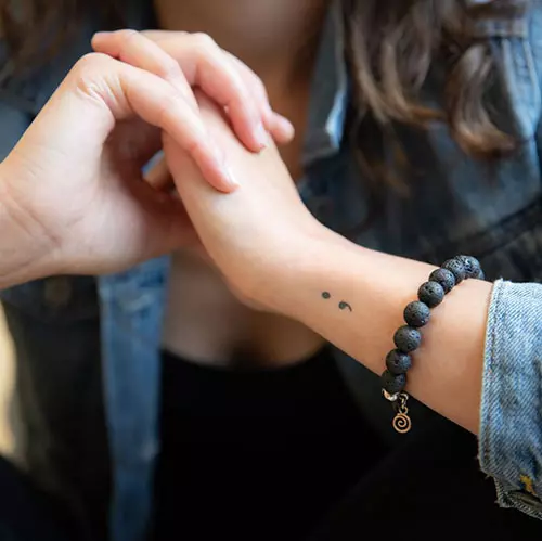 Semicolon tattoo design on wrist