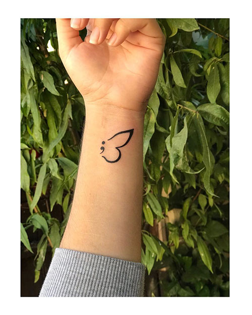Semicolon tattoo design with butterfly wings