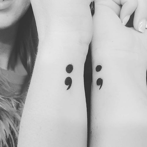 Simple semicolon tattoo design made on the wrist