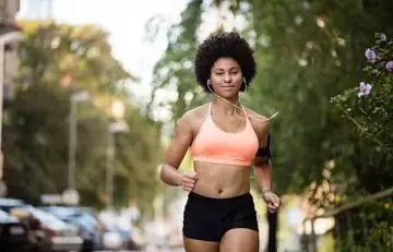 A woman is performing cardio exercise.