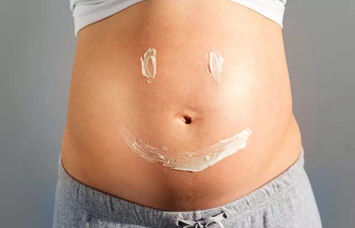 Woman with prescribed topical ointment applied to stretch marks to prevent itchiness