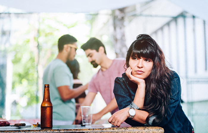 Woman feeling bored. awkward, and left out at a party