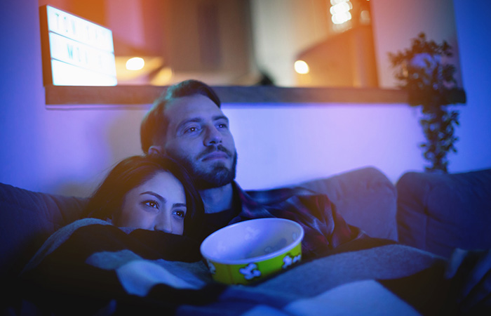 Couple watching a rom-com movie together