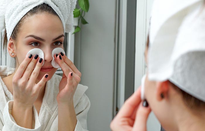 Woman dabbing makeup sponge with toner under eyes to avoid cakey makeup