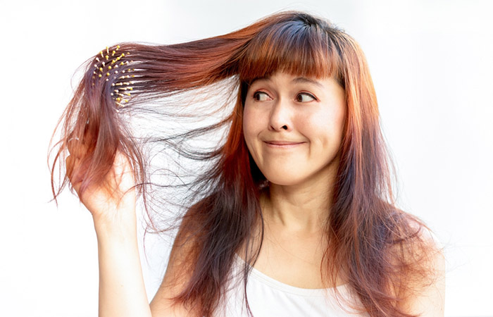 Woman detangling chemically processed hair