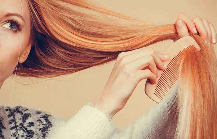 Woman detangling straight hair 