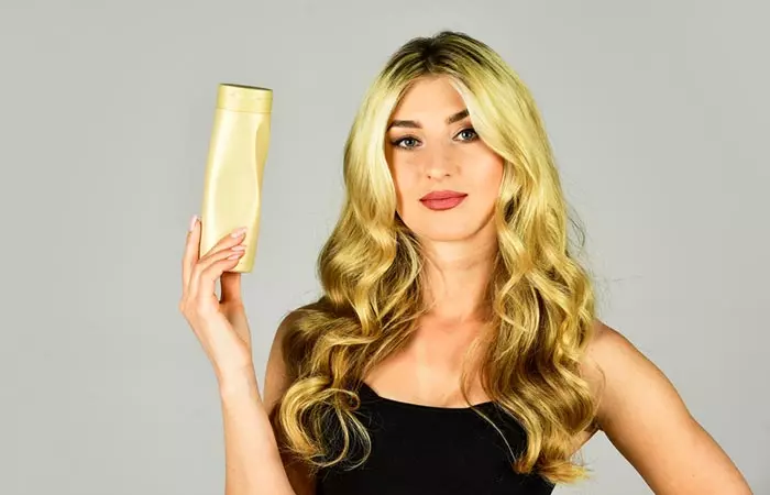Woman achieving moisturized bleached hair after using coconut oil