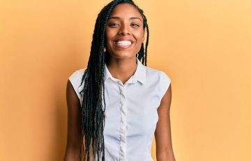 Woman smiling with protective braids