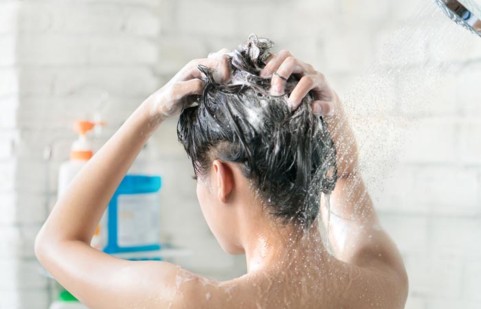 Woman using body wash as shampoo
