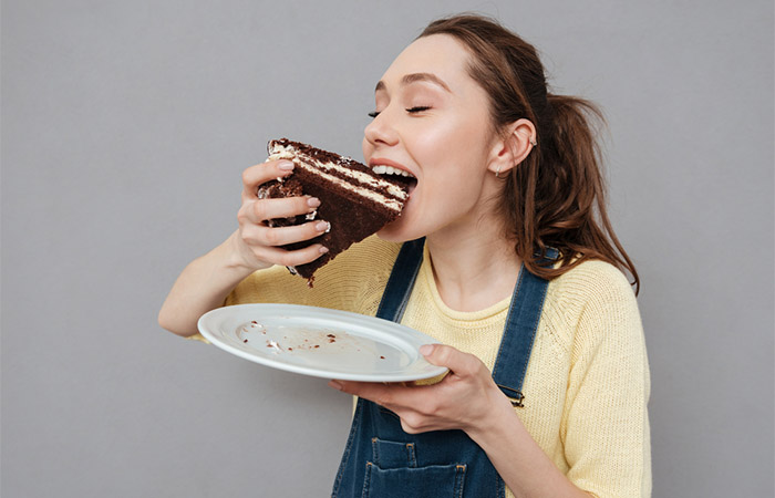 Woman eating cake must avoid sugar intake for hair growth