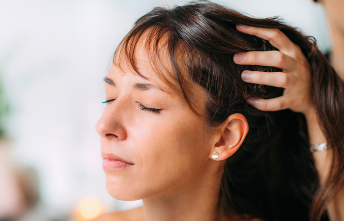 Woman getting hot oil massage hair treatment