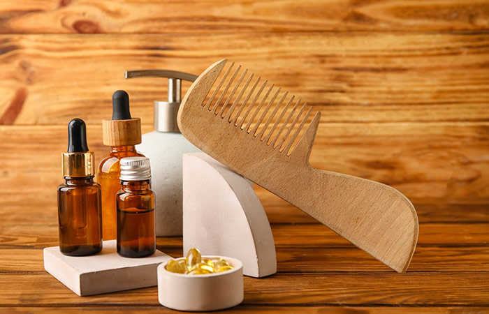 A display of fish oil capsules with other hair care products and a comb