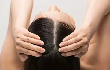 Woman revealing a healthy scalp afer taking fish oil regularly