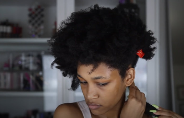 Apply a hair moisturizer to the sectioned hair for perfect twist out on 4C natural hair