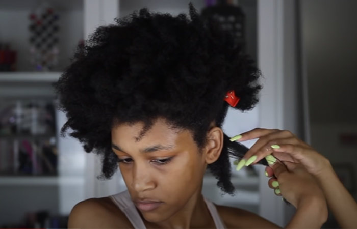 Section the hair into two for perfect twist out on 4C natural hair