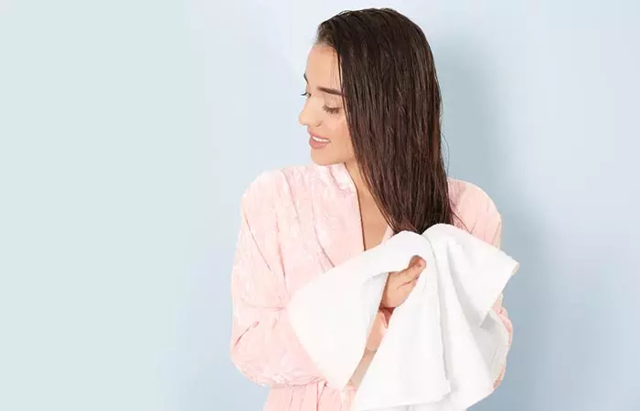 WOman uses microfiber towel to dry hair