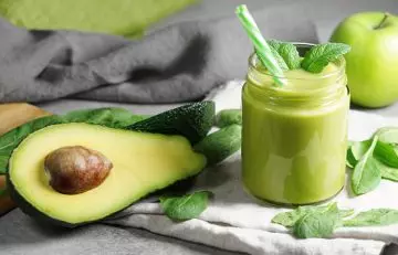 Vitamin E smoothie with avocado,, spinach and mint leaves for boosting hair growth