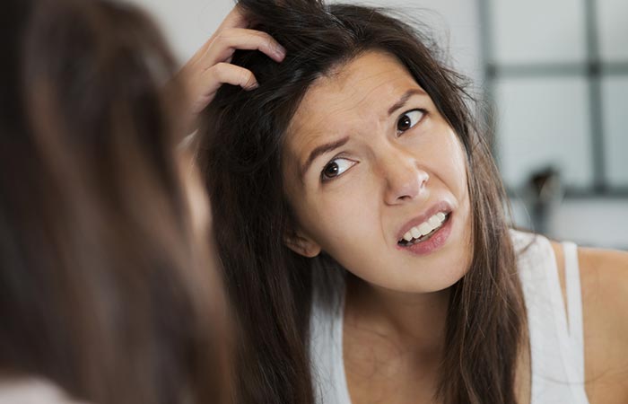 Woman with itchy scalp due to damp hair