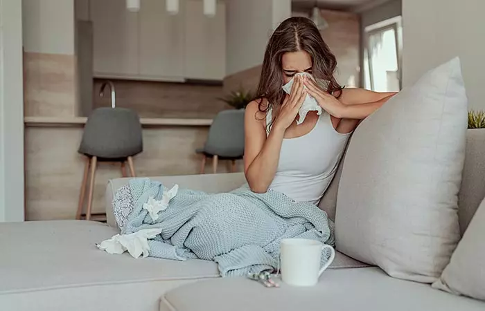 Woman with cold due to sleeping with damp hair