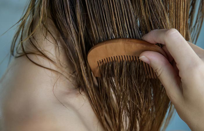Woman combing damp hair