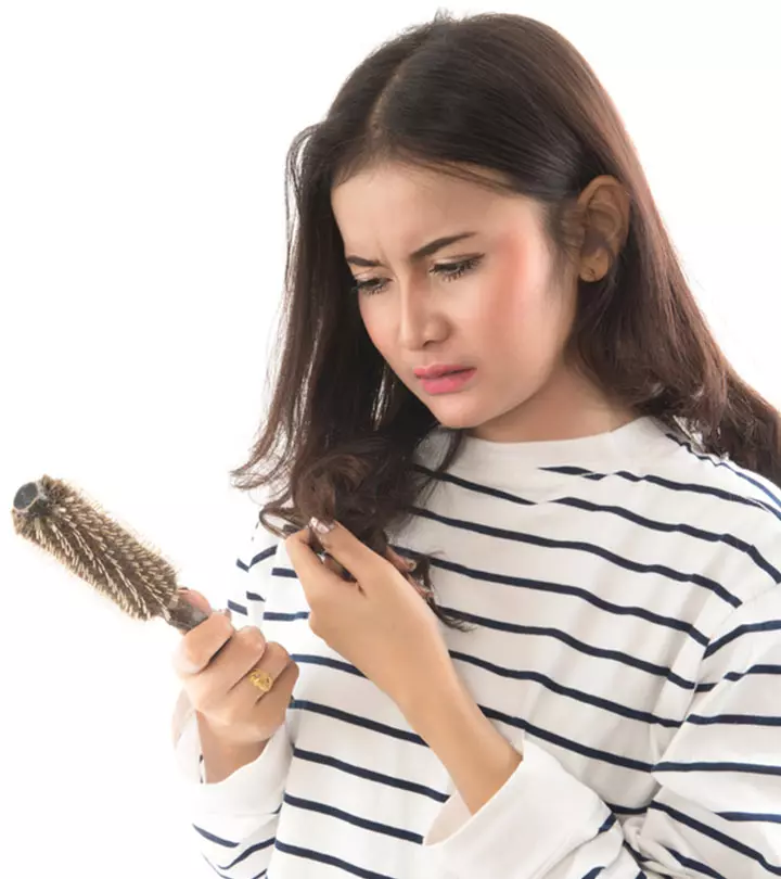 Person looking at birth control pills wondering about hair loss