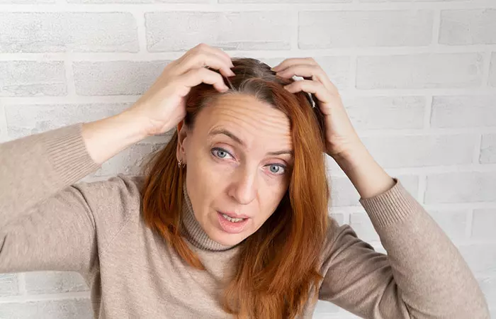 Frustrated woman after dyeing her wet hair.