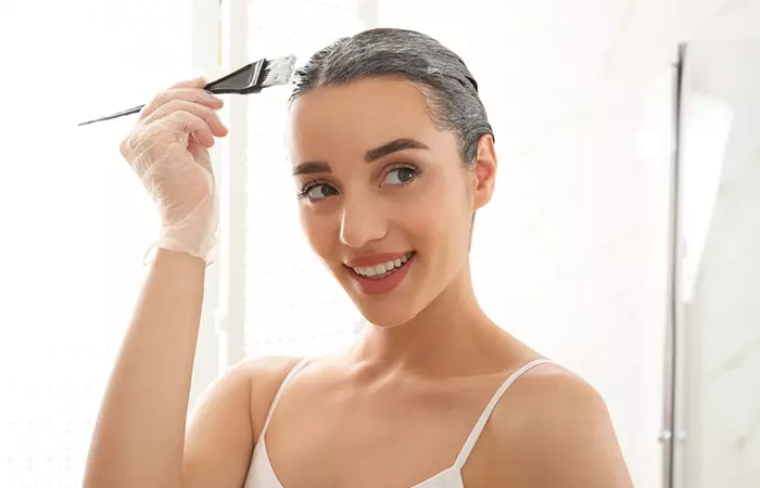 WOman bleaching damp hair fo quick hair lightening